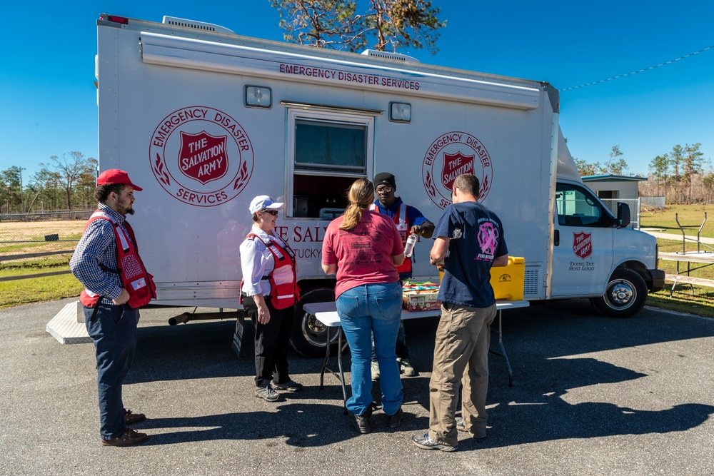 Salvation Army disaster responders distributing meals and water from a mobile relief truck in Blountstown, Florida, after Hurricane Michael in 2018.