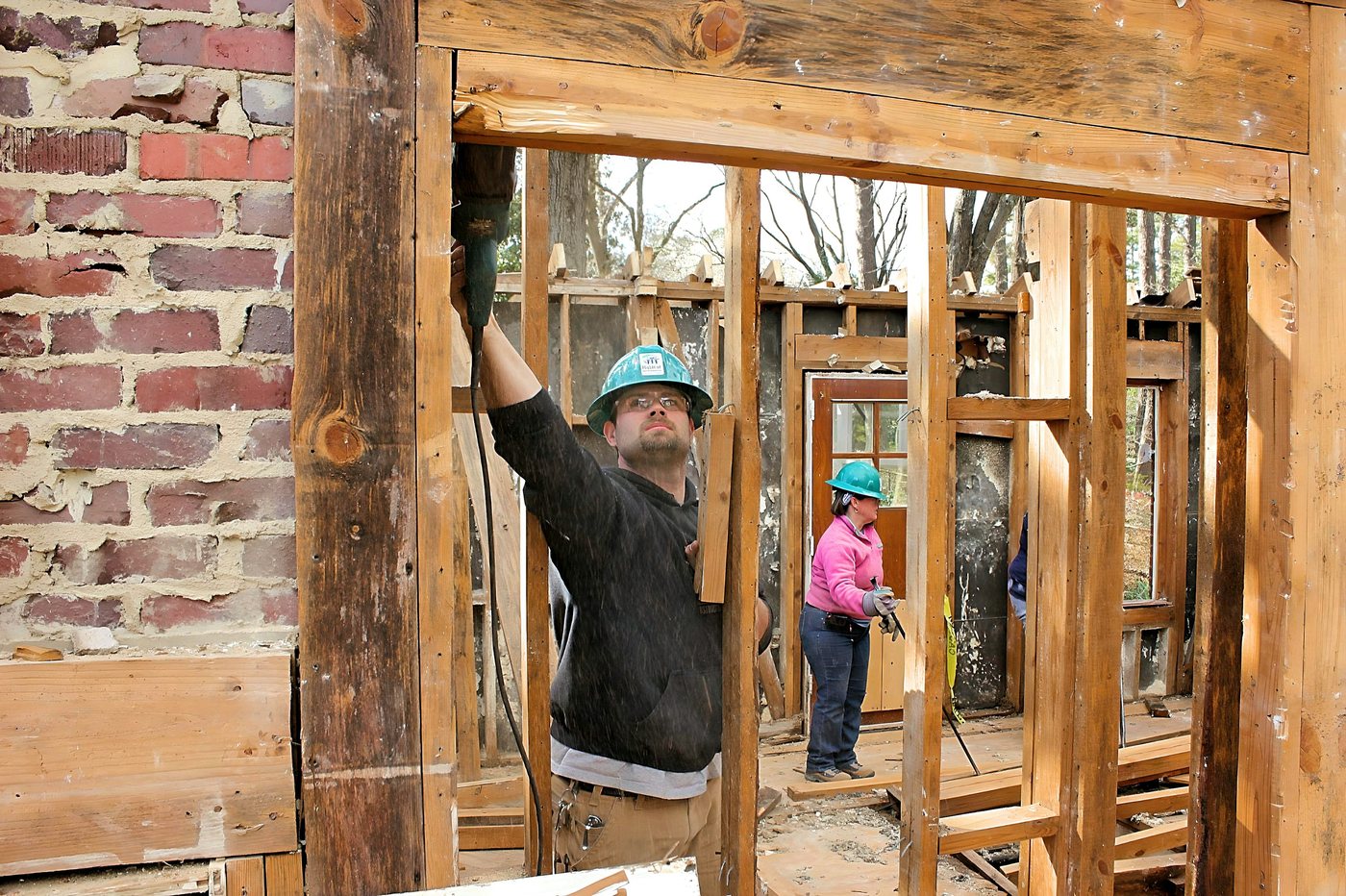 Habitat for Humanity volunteers working inside a house during a deconstruction project in Raleigh, North Carolina.